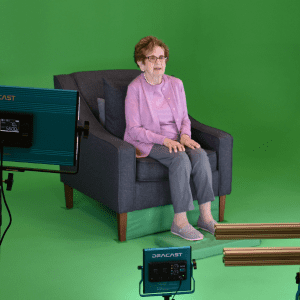 a close up photo of holocaust survivor Halina Zimm sitting in a chair being filmed for her DIT