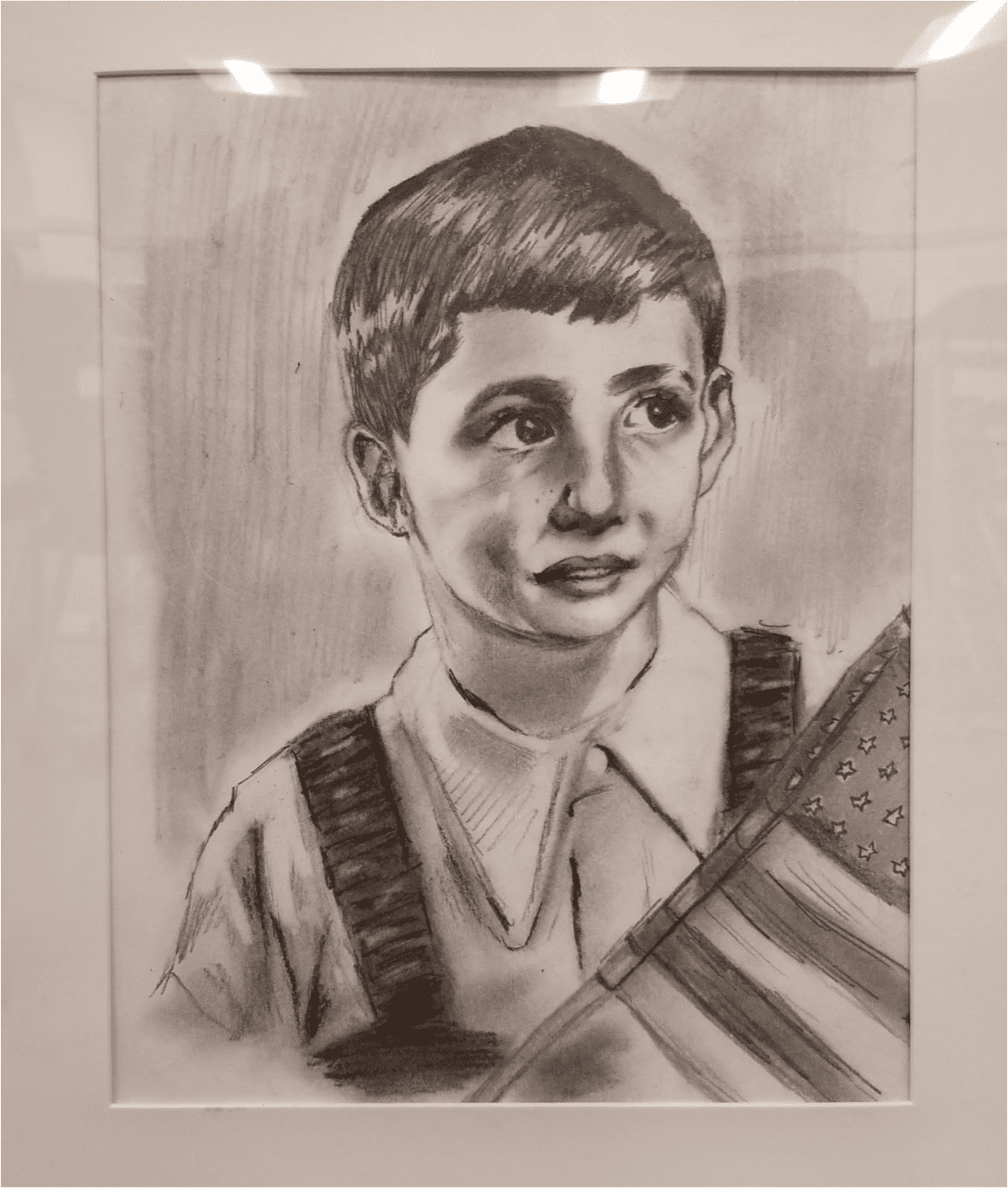 A black and white pencil drawing of Roger Loria as a young boy holding an American flag.